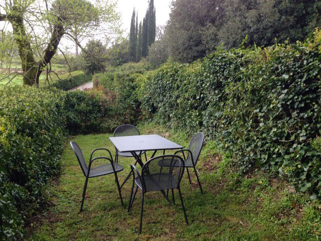 La fattoria external photo: private enclosed lawn with garden furniture